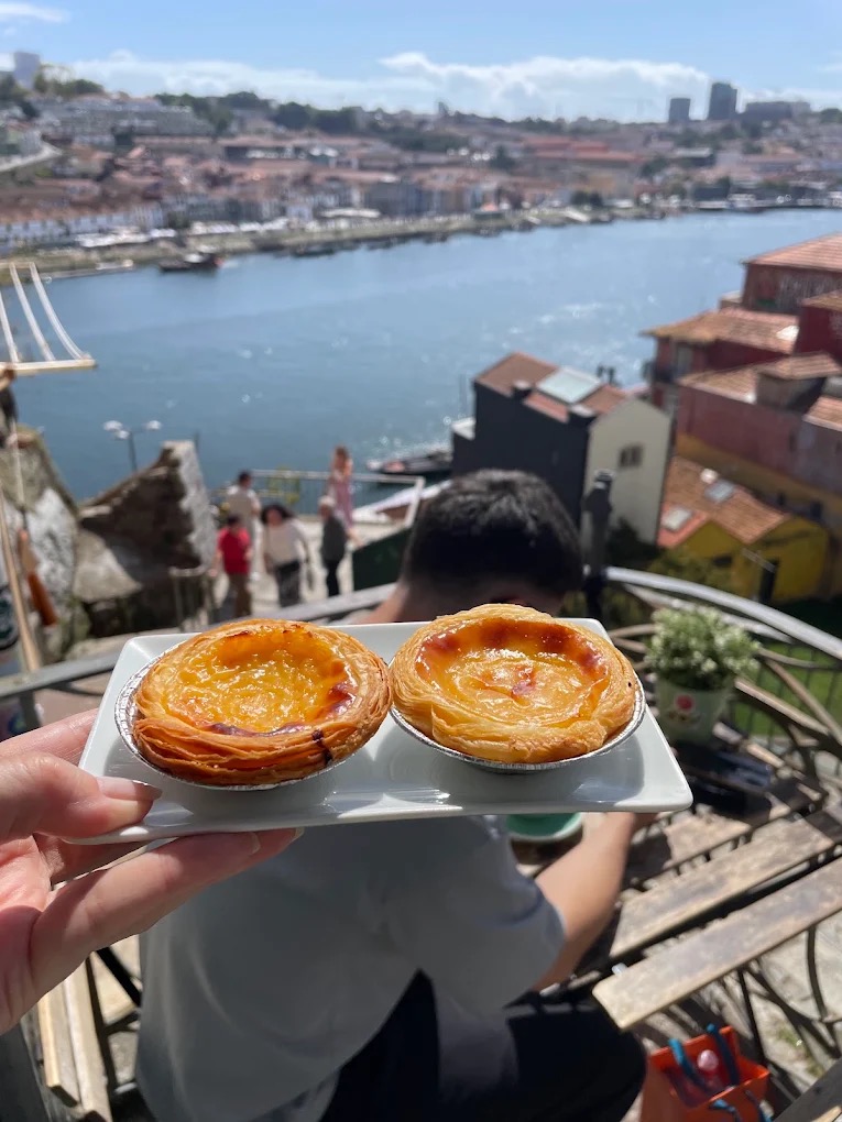 Pastéis de nata with a view over the Douro River in Porto